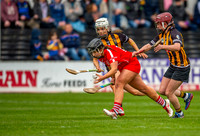 Linda Collins scoops up the ball and surges forward